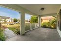 Inviting front porch with white railings and ample space for outdoor seating, offering views of the neighborhood at 3304 Kelsey Ln, St Cloud, FL 34772