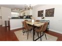 Inviting dining area features a modern light fixture, contemporary table, and wood flooring at 350 Killarney Bay Ct # 5, Winter Park, FL 32789