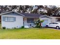 Quaint single-Gathering home featuring a lush green lawn and a one-car garage at 3520 Arch St, Orlando, FL 32808