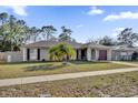 Well-maintained single-story home featuring a tidy front lawn, mature landscaping, and a convenient driveway at 4804 Beacon St, Orlando, FL 32808