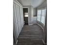 Bright bedroom features wood-look flooring, ample closet space, and natural light from the bay window at 50989 Highway 27 # 105, Davenport, FL 33897