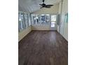 Bright sunroom with wood-look flooring and multiple windows that offer lots of natural light at 50989 Highway 27 # 105, Davenport, FL 33897