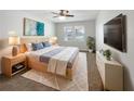 Stylishly decorated bedroom with soft rug, modern furniture, and natural lighting at 5323 Rochester Pl, St Cloud, FL 34771