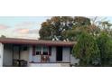 Inviting single-story home displaying a front porch area, enhanced with a beautiful shade tree at 5711 Riordan Way, Orlando, FL 32808