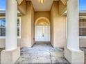 Exterior view of front door and covered entrance with column supports at 603 Deauville Ct, Kissimmee, FL 34758