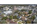An aerial view of a neighborhood with mature trees and sidewalks close to the shops, restaurants, and businesses in town at 627 N Hyer Ave, Orlando, FL 32803