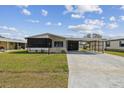 Charming single-story home with a well-manicured lawn and a covered carport at 721 Polo Park Blvd, Davenport, FL 33897