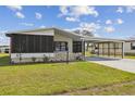 Charming home featuring a screened-in porch and a covered carport, complemented by a well-maintained lawn at 721 Polo Park Blvd, Davenport, FL 33897