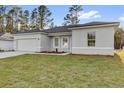 Attractive single-story home with a well-manicured lawn, attached garage, and neutral-colored exterior at 773 Marion Oaks Pass, Ocala, FL 34473