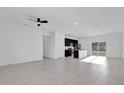 Bright, open-concept living room featuring tile floors and an attached kitchen at 773 Marion Oaks Pass, Ocala, FL 34473