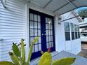 Close-up of the home's entrance with attractive blue double doors and modern exterior at 9000 Us Highway 192 # 835, Clermont, FL 34714