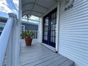 Covered porch showing the blue double doors and a glimpse of the neighborhood at 9000 Us Highway 192 # 835, Clermont, FL 34714