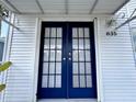 The home's entrance features stylish blue double doors with glass panels and silver hardware at 9000 Us Highway 192 # 835, Clermont, FL 34714