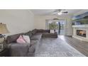 Spacious living room with a fireplace, large sectional sofa, and sliding glass doors to the outside at 1024 Harbor Hill St, Winter Garden, FL 34787