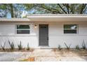 Charming single-story home with a gray front door, white brick, and freshly landscaped with green plants at 103 Ford Ave, Altamonte Springs, FL 32701