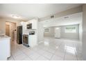 Bright kitchen with stainless steel appliances, white cabinets, tile floor, and open floorplan at 103 Ford Ave, Altamonte Springs, FL 32701