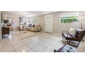 Spacious living room with tile flooring, neutral decor, comfortable seating, and a bright and airy feel at 103 Ford Ave, Altamonte Springs, FL 32701