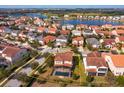 Aerial view of a neighborhood with a lake and a beautiful home with a private pool at 15672 Shorebird Ln, Winter Garden, FL 34787