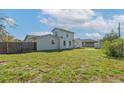 Large backyard featuring a wooden fence for privacy, a well-maintained lawn and an outbuilding for storage at 1597 Lansfield Ave, Deltona, FL 32738