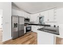 Modern kitchen with stainless steel appliances, granite countertops, and sleek white cabinetry at 1597 Lansfield Ave, Deltona, FL 32738