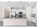 Modern kitchen featuring white cabinets, granite countertops, and stainless steel appliances at 1598 Barberry Dr, Kissimmee, FL 34744
