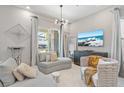 Elegant living room with comfortable seating, large windows, and stylish decor at 1763 Standing Rock Cir, Oakland, FL 34787