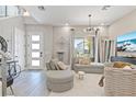 Bright living room features modern decor, tile floors, and large windows offering ample natural light at 1763 Standing Rock Cir, Oakland, FL 34787