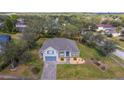 Inviting single-Gathering home featuring a well-manicured lawn and brick-paved driveway at 3978 Old Dunn Rd, Apopka, FL 32712