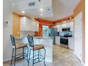 Bright kitchen with stainless steel appliances, breakfast bar, and stylish counter stools at 5300 S Atlantic Ave # 6-206, New Smyrna Beach, FL 32169