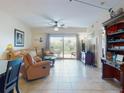 Comfortable living area with plush seating, tile floors, and access to a balcony at 5300 S Atlantic Ave # 6-206, New Smyrna Beach, FL 32169