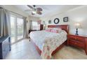 Cozy bedroom featuring a ceiling fan, balcony access, and beautiful furnishings for relaxation at 5300 S Atlantic Ave # 6-206, New Smyrna Beach, FL 32169