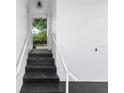 A view of the home's entrance, with a dark stairway leading up to the front door and a clean, bright white exterior at 5508 Meridian Way, Orlando, FL 32808