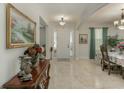 Bright and airy front foyer featuring tile flooring and a beautiful chandelier at 619 Meadow Sage Dr, Deland, FL 32724