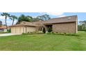 Well-maintained one-story home with manicured lawn and mature landscaping, offering curb appeal at 6766 Edgeworth Dr, Orlando, FL 32819