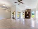 Spacious living room with fireplace, tile floors, ceiling fan, and sliding glass doors to the outside at 6766 Edgeworth Dr, Orlando, FL 32819