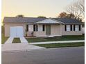 Charming single-story home featuring neutral paint, black shutters, and a well-maintained lawn at 106 Dahlia Dr, Kissimmee, FL 34743