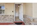 Inviting entryway with tiled floors, neutral paint, and brick accents around the porch area at 1157 Schooner Dr, Kissimmee, FL 34744