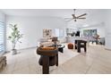 Bright living room with vaulted ceiling, neutral colors, and tile floors at 1188 La Mesa Ave, Winter Springs, FL 32708