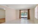 Bright living room featuring tiled floor and sliding glass door to the backyard at 1248 Woodman Way, Orlando, FL 32818