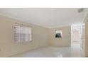 Bright living room featuring tiled floor and a view into the kitchen at 1248 Woodman Way, Orlando, FL 32818