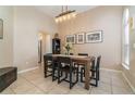 Dining room with modern table and chairs, complemented by neutral walls, tile floors, and stylish decor at 1428 Oberlin Ter, Lake Mary, FL 32746