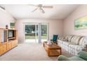 Bright living room with sliding glass doors leading to the backyard at 15204 Margaux Dr, Clermont, FL 34714