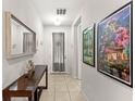 Inviting hallway featuring tile floors and stylish decor at 1547 Carey Palm Cir, Kissimmee, FL 34747