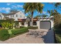 Inviting single-story home with lush landscaping, brick driveway, and a cozy front yard at 1585 Chestnut Ave, Winter Park, FL 32789