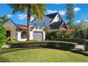 Attractive home showcasing neat landscaping, a gray garage door, and a clay tile roof at 1585 Chestnut Ave, Winter Park, FL 32789