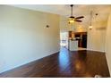 Inviting living room featuring sleek wood floors, a ceiling fan, and seamlessly connects to the kitchen area at 1932 Lake Atriums Cir # 74, Orlando, FL 32839