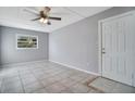 Cozy bedroom with tile flooring, ceiling fan, and a bright window at 210 Cadillac Ct, Altamonte Springs, FL 32701