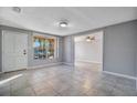 Inviting living room with tile flooring, ample natural light, and neutral paint at 210 Cadillac Ct, Altamonte Springs, FL 32701