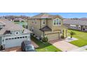 Beautiful two-story home featuring a two-car garage, brick driveway, and a lush green lawn at 2687 Chantilly Ave, Kissimmee, FL 34741