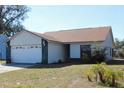 Exterior of single Gathering home featuring an attached two car garage and mature landscaping at 274 W 20Th St, Apopka, FL 32703